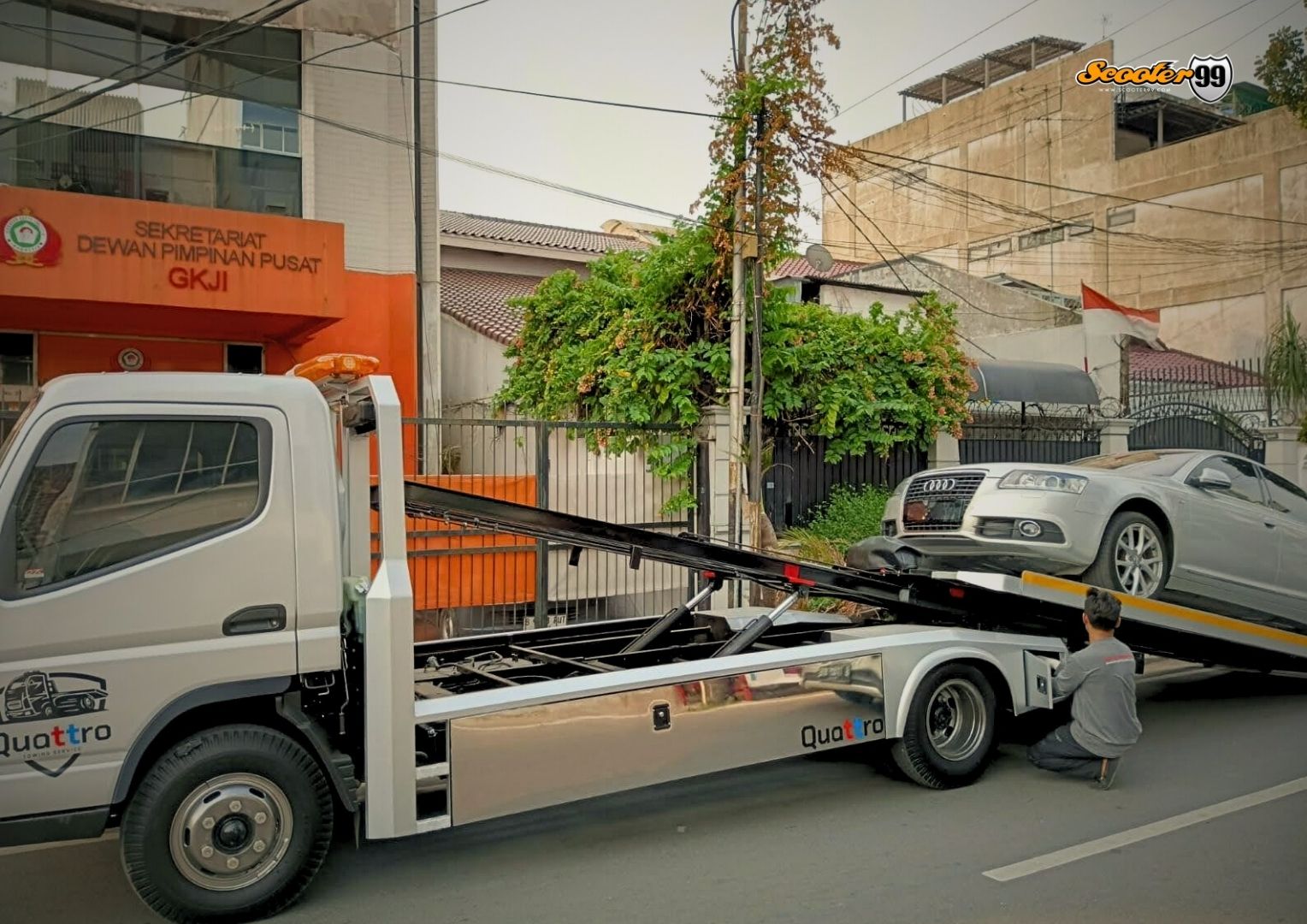 Towing truck in action, securing a vehicle on the roadside